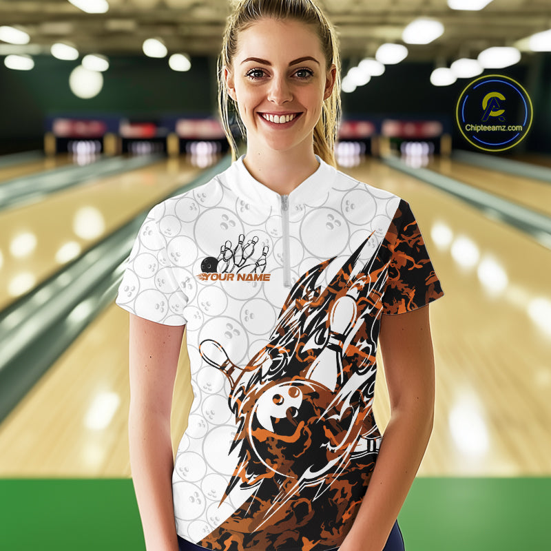 Female model wearing a white bowling quarter-zip shirt at the bowling lane with yellow camo bowling artwork and faint ball details.