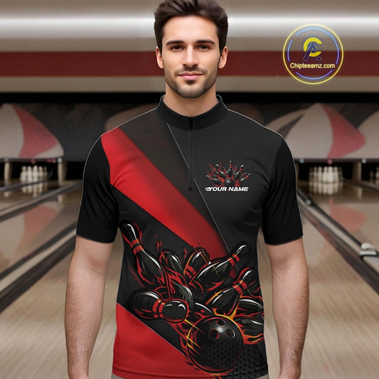 Male model at the bowling lane wearing a black and red quarter zip shirt, showcasing a flaming bowling ball knocking down pins in a powerful sports action scene.