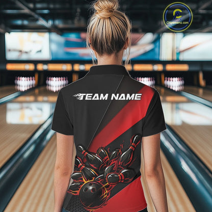 Back view female model inside bowling venue wearing black and red quarter zip shirt featuring flaming bowling ball hitting pins design