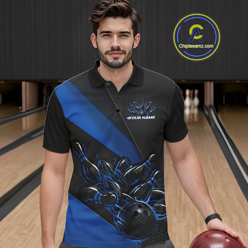 Male model seen from the front in a bowling lane wearing a black and blue polo shirt featuring a flame bowling ball striking pins in a dynamic sports action scene.