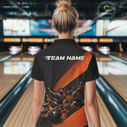 Female model back view at bowling lane wearing a black and orange polo shirt with flaming bowling ball hitting pins in bold athletic motion design.