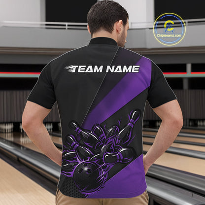 Male model front view at bowling lane wearing black and purple quarter zip shirt with flaming bowling ball knocking down pins design
