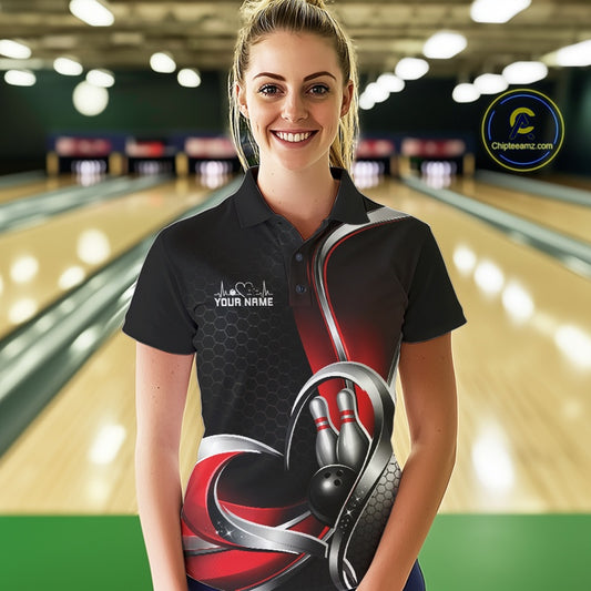 Female model in a bowling alley wearing a black and red polo shirt with honeycomb accents and a heart-framed bowling strike illustration.