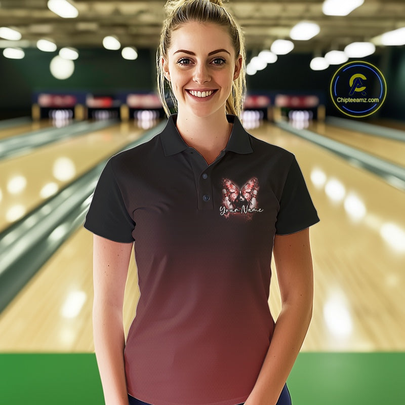 Female model at a bowling lane wearing a red bowling polo shirt with glowing butterflies, a bowling ball centerpiece, and cosmic-themed artwork.