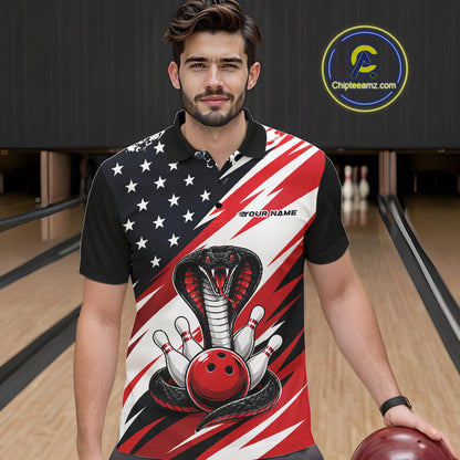 A man stands in a bowling alley wearing a black, white, and red bowling shirt with stars, diagonal stripes, a cobra, pins, and an red ball.