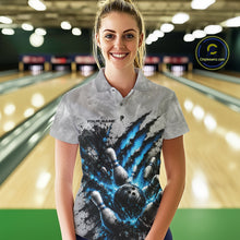 Load image into Gallery viewer, Front view of a female model wearing a gray bowling polo shirt featuring a dramatic blue bowling ball and pins graphic with claw-mark artwork in a bowling lane.