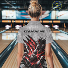 Load image into Gallery viewer, Back view of a female model wearing a gray bowling polo shirt featuring a dramatic red bowling ball and pins graphic with claw-mark artwork in a bowling lane.