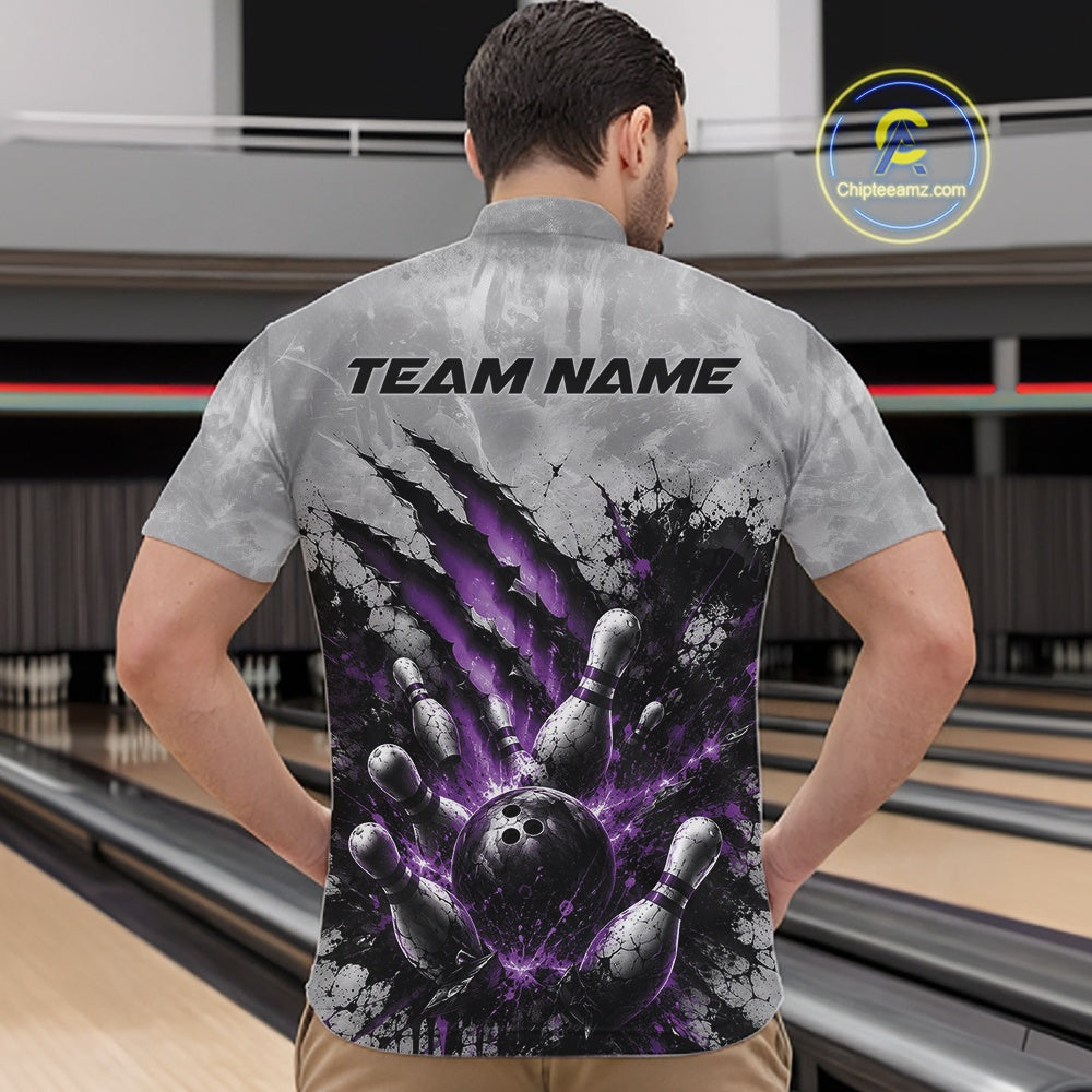 Front view of a male model wearing a gray bowling quarter zip shirt showcasing a dramatic purple bowling ball and pins graphic with claw-mark artwork at a bowling lane.