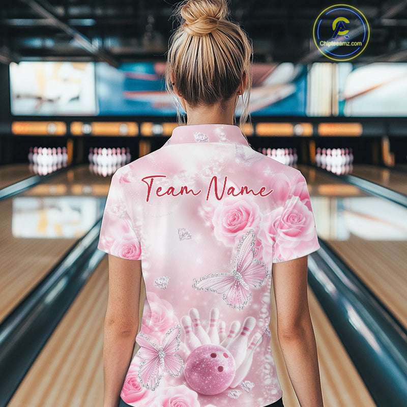 Back view of a female model in a bowling venue wearing a bowling polo shirt showcasing glitter butterflies, roses, bowling pins, and bowling graphics.