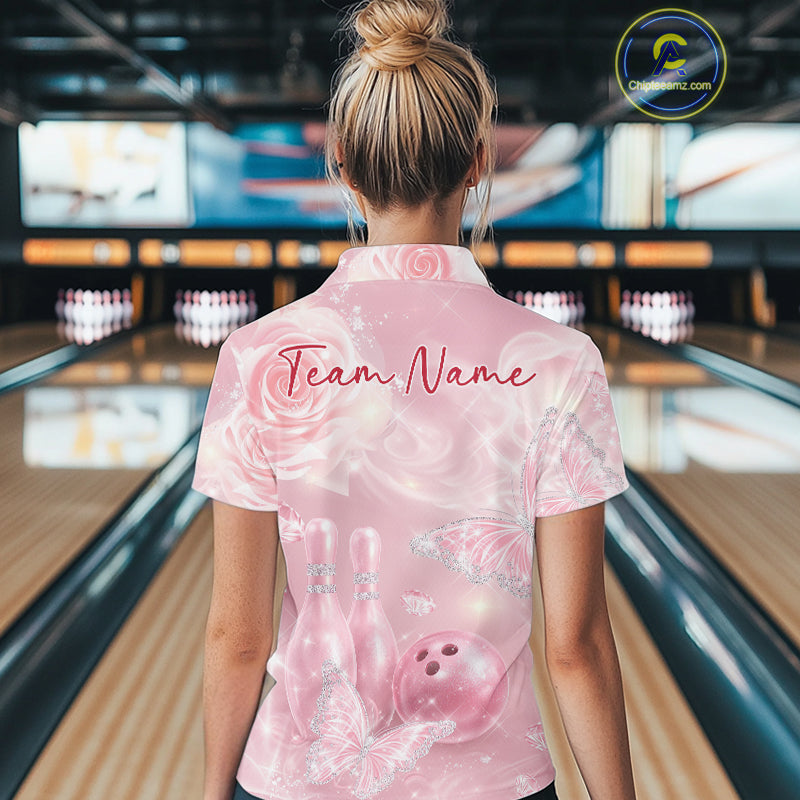 Back view of a female model wearing a bowling polo shirt featuring sparkling pink butterflies, floral roses, bowling pins, and bowling ball graphics.