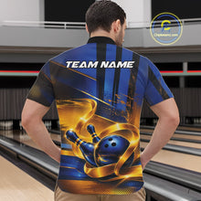 Load image into Gallery viewer, Male model wearing a bowling quarter zip shirt with a glossy blue bowling ball striking pins and flowing gold ribbon artwork, shown from the front in a bowling lane.