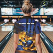 Load image into Gallery viewer, Back view of a female model wearing a bowling quarter zip shirt with a glossy blue bowling ball and pins illustration wrapped in flowing gold ribbons at a bowling lane.