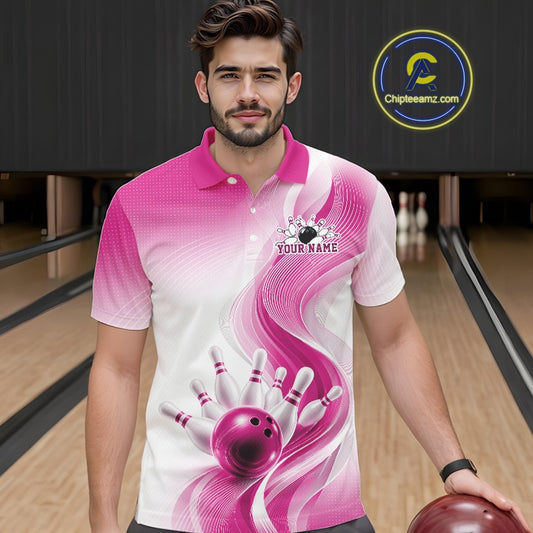 Male model wearing a white and pink bowling polo shirt with flowing abstract wave graphics and a glossy bowling ball striking pins at the bowling lane, front view