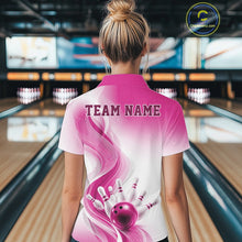 Load image into Gallery viewer, Female model in a bowling alley displaying the back of a white and pink bowling quarter-zip shirt with bowling action artwork