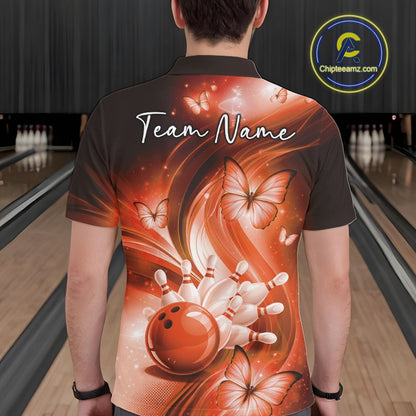 Back view of an orange bowling polo displaying a bowling ball knocking down pins with butterfly details.
