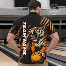 Load image into Gallery viewer, Front view of a male model at a bowling lane wearing a black and yellow bowling quarter-zip shirt featuring a roaring tiger holding a yellow bowling ball with orange claw-stripe artwork and a geometric background pattern.