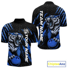 Load image into Gallery viewer, Front and back view of a black and mid blue men's bowling quarter-zip shirt showcasing a roaring tiger holding a mid blue bowling ball with matching claw-stripe artwork and a geometric background pattern.