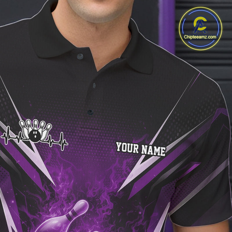 Close-up of the left chest graphic on a black and purple bowling polo featuring a flaming bowling strike illustration.