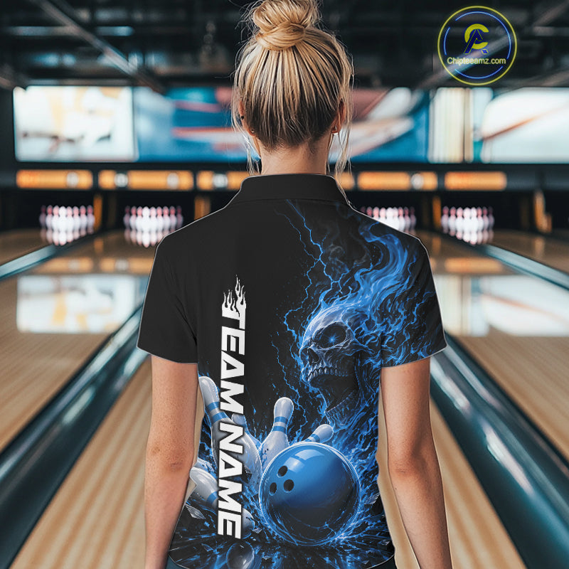 Back view of a female model in a bowling alley wearing a black bowling polo with a blue flaming skull, lightning, bowling pins, and a custom name.
