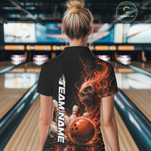 Load image into Gallery viewer, Back view of a female model in a bowling alley wearing a black bowling quarter zip shirt featuring an orange fiery skull with lightning striking a bowling ball and pins and a custom name.
