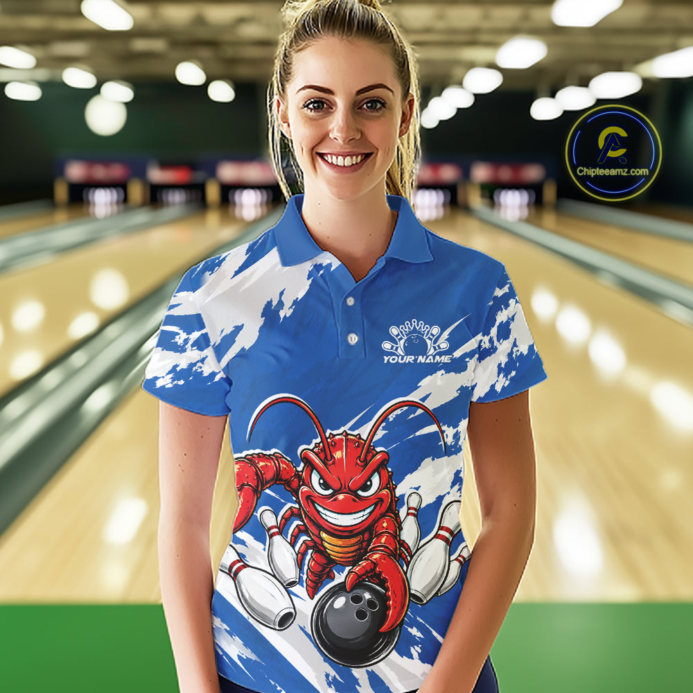 Front view of a female model in a bowling alley wearing a blue custom bowling polo shirt with a fierce yet funny crawfish bowling character and a distressed background design.