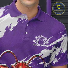 Load image into Gallery viewer, Close up front view of the left chest area on a purple custom bowling polo shirt featuring a fierce yet funny crawfish bowling character and a distressed background design.
