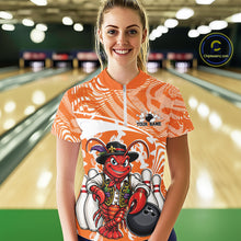 Load image into Gallery viewer, Front view of a happy female model in a bowling alley wearing an orange custom quarter-zip bowling shirt with a funny Cajun crawfish leaning on a bowling ball and a swamp-inspired texture background.