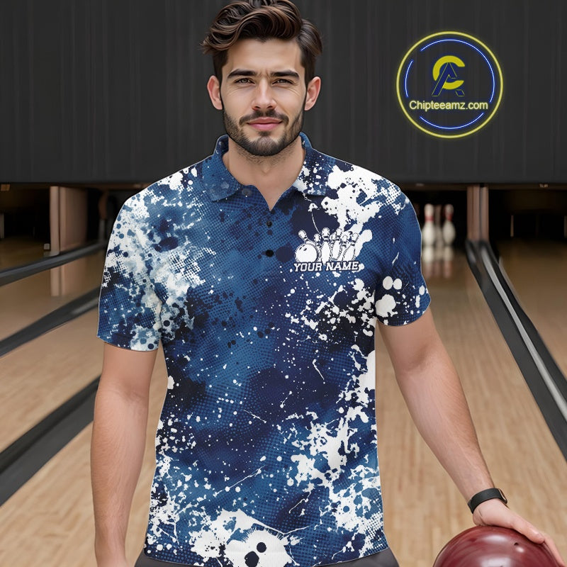 Front view of a female model in a bowling alley wearing a purple bowling polo shirt featuring a white paint splatter sportswear design.

