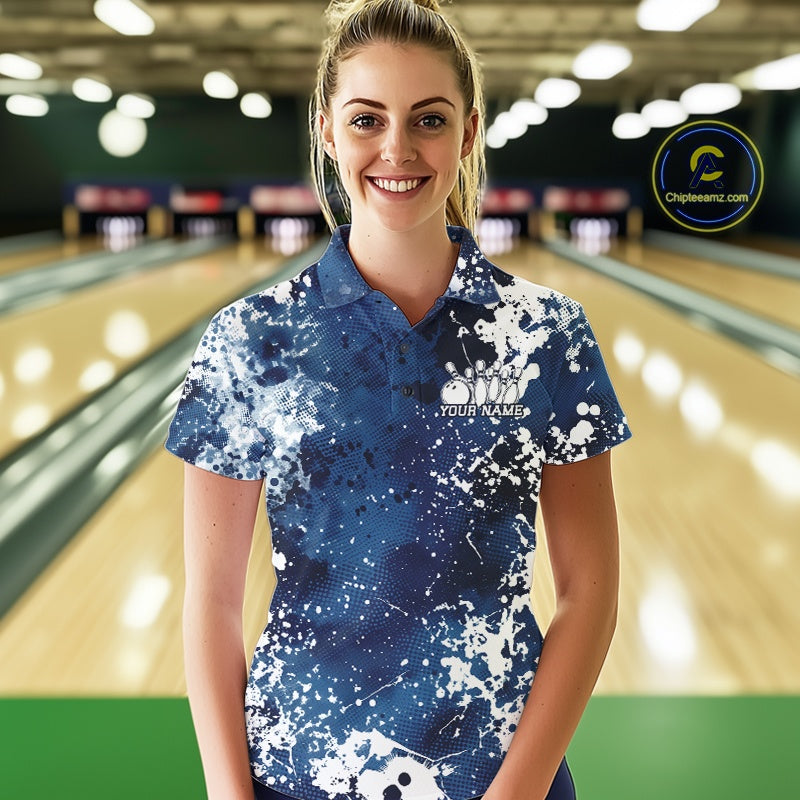 Woman wearing a blue and white bowling shirt with 'Your Name' printed on it, standing in a bowling alley.
