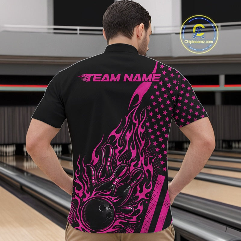 Front view of a male model in a bowling venue wearing a black quarter-zip shirt featuring a pink flaming bowling ball and pin graphics.