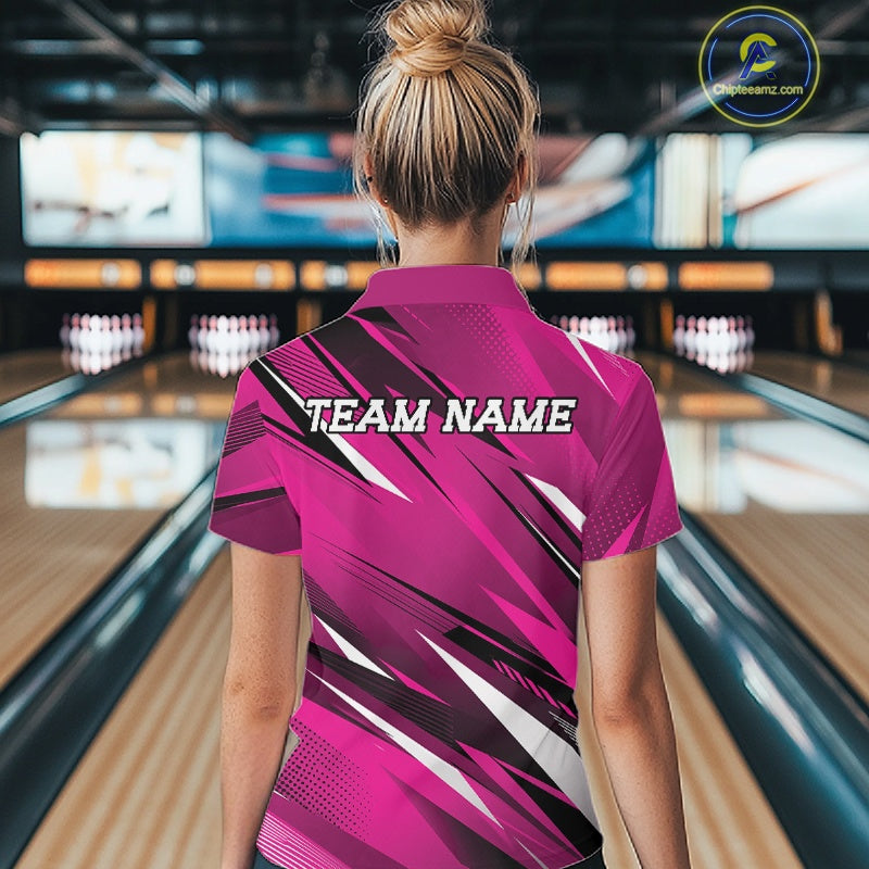 Person wearing a pink bowling shirt with 'TEAM NAME' on the back in a bowling alley.