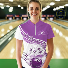 Load image into Gallery viewer, Female model in a white and purple bowling quarter zip featuring butterfly graphics and bowling artwork, front view at the bowling lane