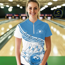 Load image into Gallery viewer, Female model wearing a white and blue bowling quarter zip with butterfly artwork and bowling graphics, front view inside a bowling alley