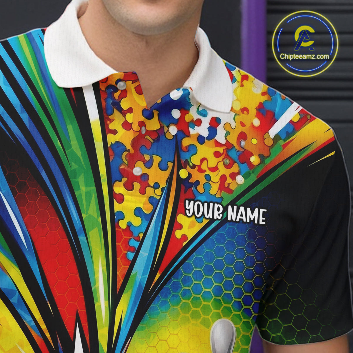 Close-up left chest detail of white bowling polo shirt showcasing autism bowling strike emblem with vibrant puzzle-themed graphics