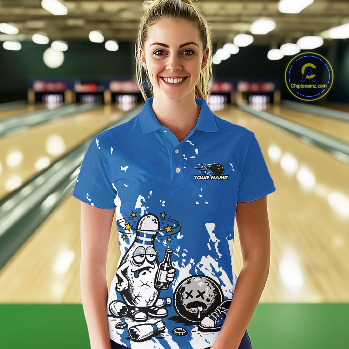 Female model in a bowling lane wearing a blue and white polo shirt, playful drunk bowling pin artwork with beer bottle and bowling ball.