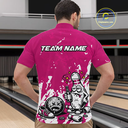 Male model at a bowling lane wearing a pink and white quarter-zip shirt, splatter-themed drunk bowling pin artwork with beer bottle and ball.