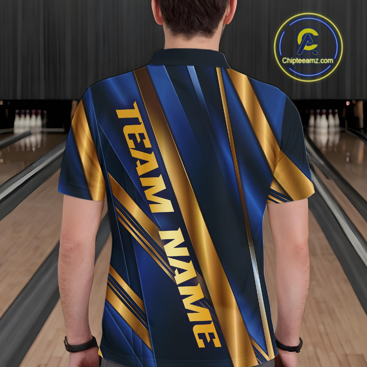 A person viewed from behind wearing a short-sleeve bowling shirt with a blue and gold graphic design that reads 'TEAM NAME'. Bowling lanes are visible in the background, and a circular 'Chipteeamz.