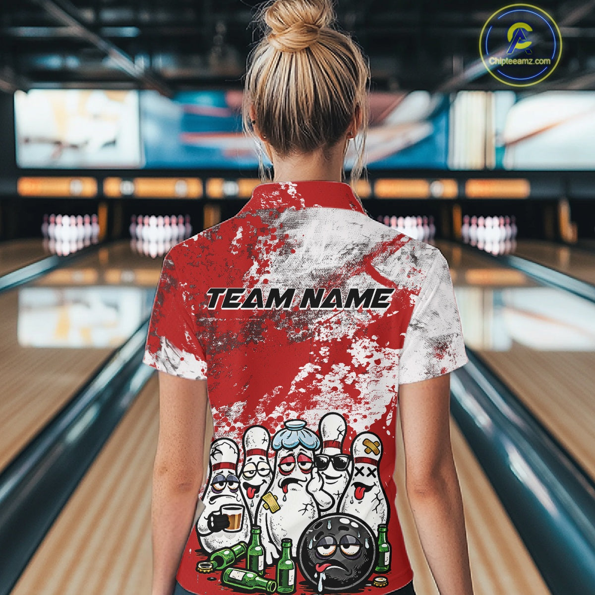 Back view of a female model in a bowling lane wearing a red and white grunge splatter bowling quarter-zip shirt with cartoon bowling pins, bowling ball, and beer bottle illustration.