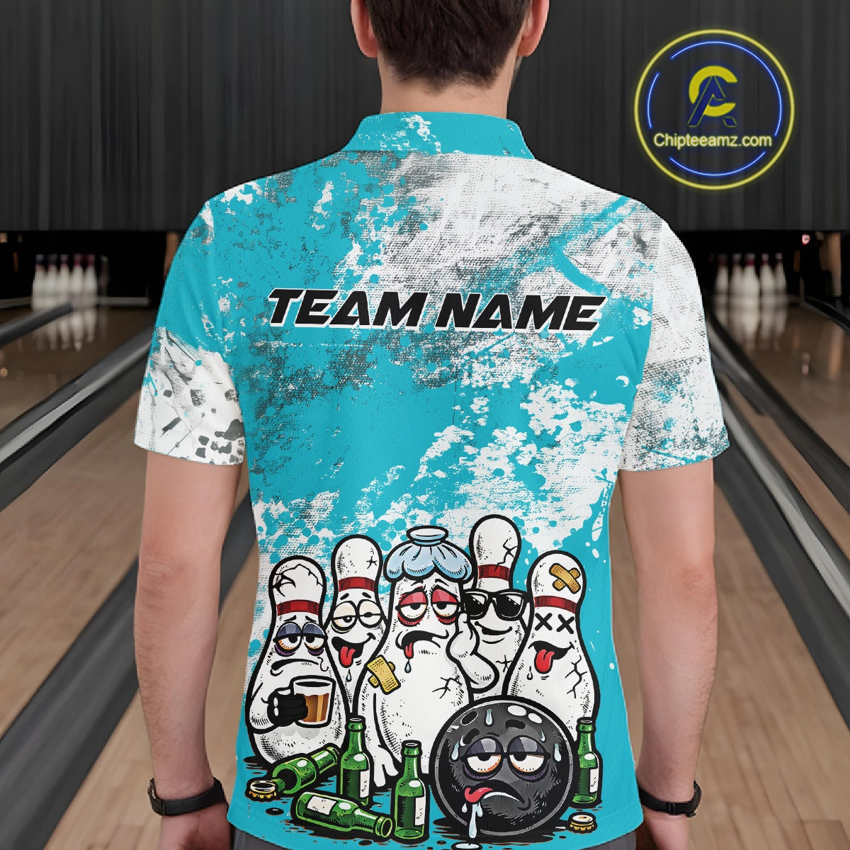 Back view of a male model in a bowling lane wearing a turquoise blue and white grunge splatter polo shirt featuring playful bowling pins and beer bottle illustration.