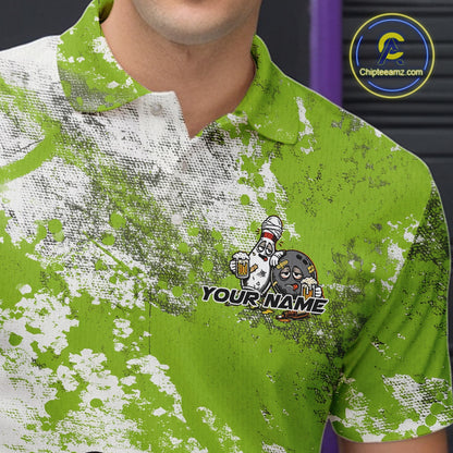 Close-up view of the left chest of a green and white grunge splatter bowling polo shirt featuring cartoon bowling pins and beer bottles around a bowling ball.