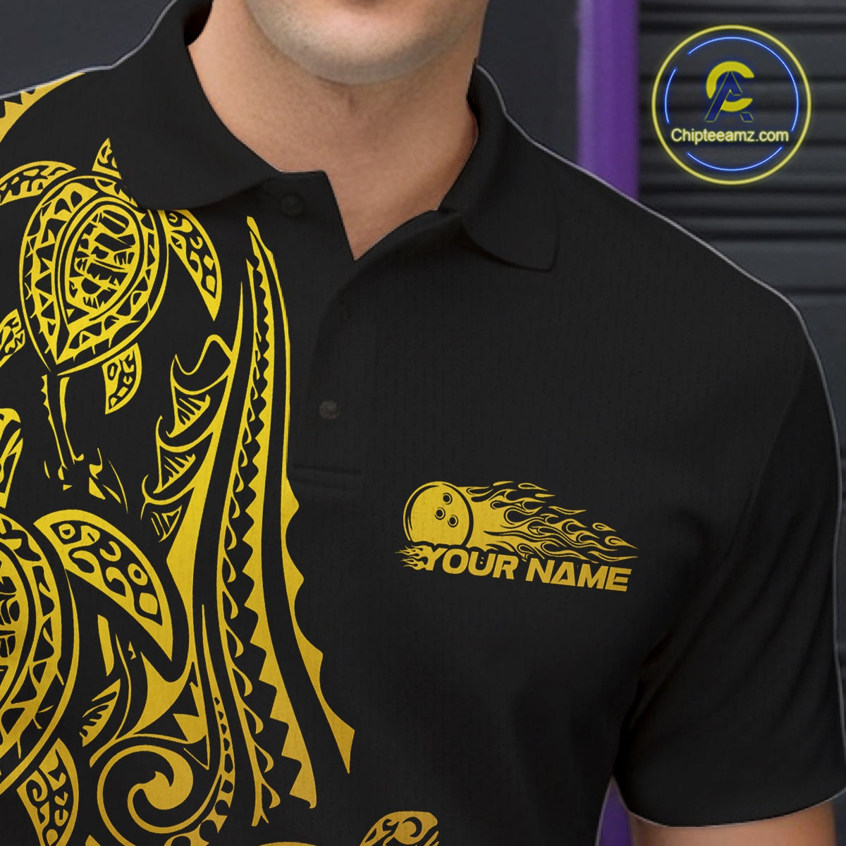 Close-up left chest detail of a black and gold bowling polo shirt featuring turtle-pattern bowling artwork.