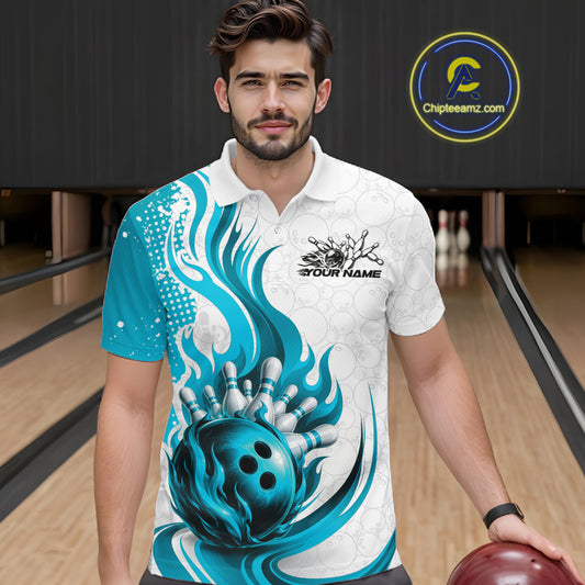 A man wearing a custom bowling polo shirt with a blue and white flame-and-bowling-ball graphic, standing in a bowling alley. The shirt features a white base with teal and blue abstract swirls, a large teal bowling ball graphic, and a black 'YOUR NAME' logo on the chest.