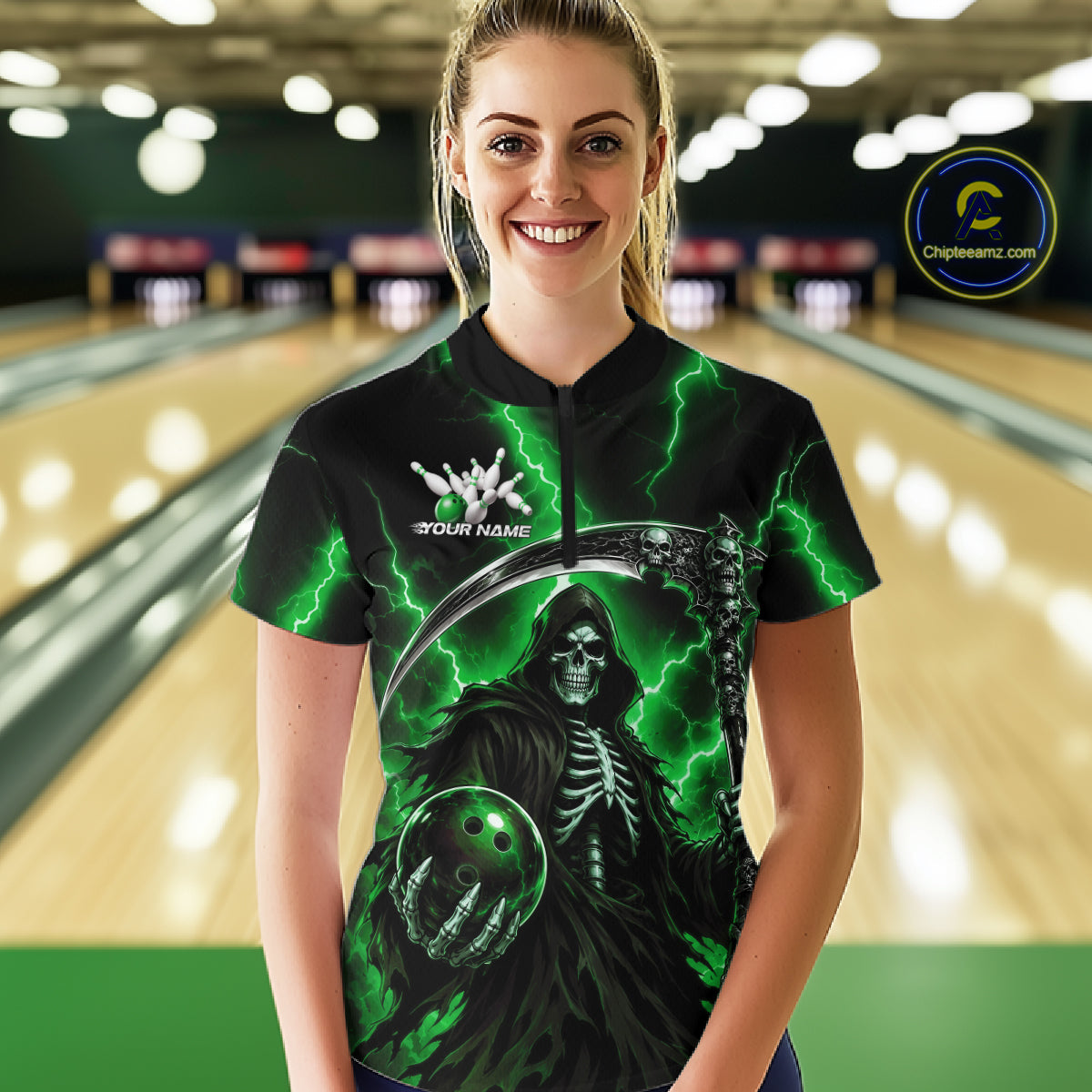 A woman stands in a bowling alley wearing a black short-sleeve bowling shirt with a green Grim Reaper graphic, lightning bolts, and a white 'YOUR NAME' text on the chest. The background shows blurred bowling lanes.