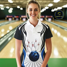 Load image into Gallery viewer, Front view of a female model wearing a white, black, and blue bowling polo shirt with bowling ball striking pins graphics in a bowling lane.