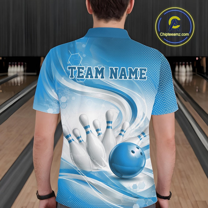 Back view of a male model wearing a white and blue bowling polo shirt featuring flowing wave graphics and a glossy bowling strike design in a bowling alley