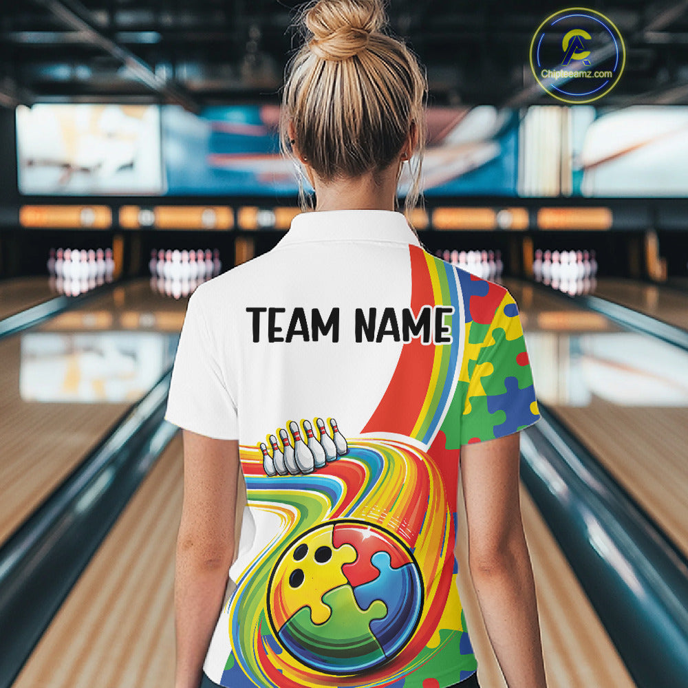 Female model at a bowling lane, back view wearing white polo shirt showcasing autism bowling lane design with vibrant puzzle elements