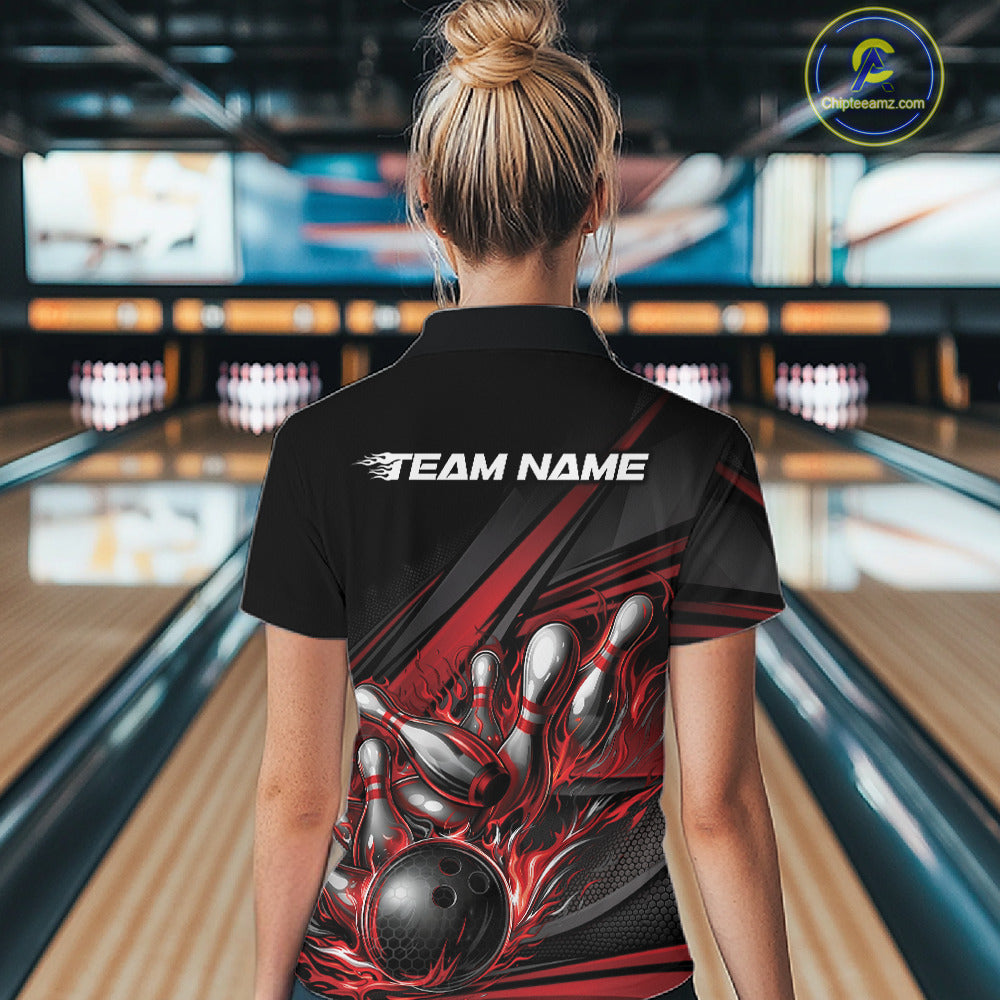 Back view of a female bowler wearing a black quarter-zip shirt, red flame bowling strike artwork with abstract stripe accents.