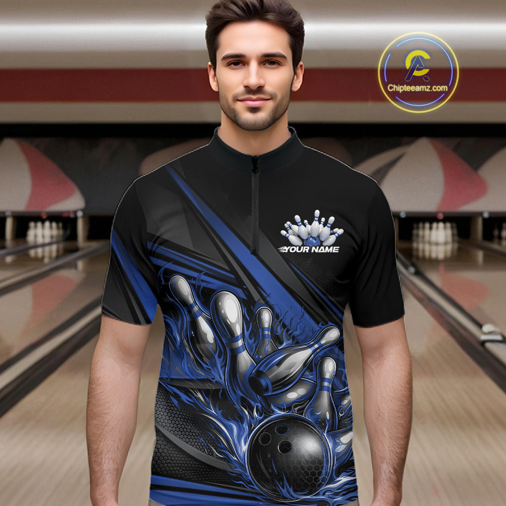 Male model in a bowling lane wearing a black quarter-zip shirt, blue flame bowling ball hitting pins with dynamic geometric stripe visuals.