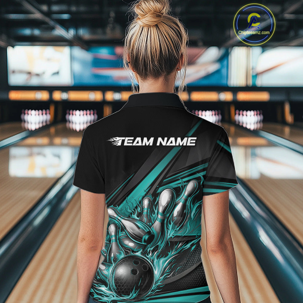 Female model at a bowling venue, back view of black polo shirt with turquoise flame bowling ball and abstract stripe graphics
