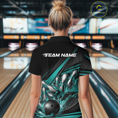 Female model at a bowling venue, back view of black polo shirt with turquoise flame bowling ball and abstract stripe graphics